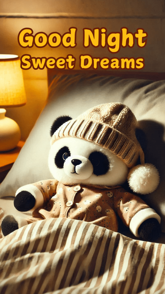 Very cute good night image of a small panda wearing a beige colour sweater & a beanie peacefully sleeping in a cozy bed. The room is illuminated by a soft, yellow bedside lamp on a small table. 